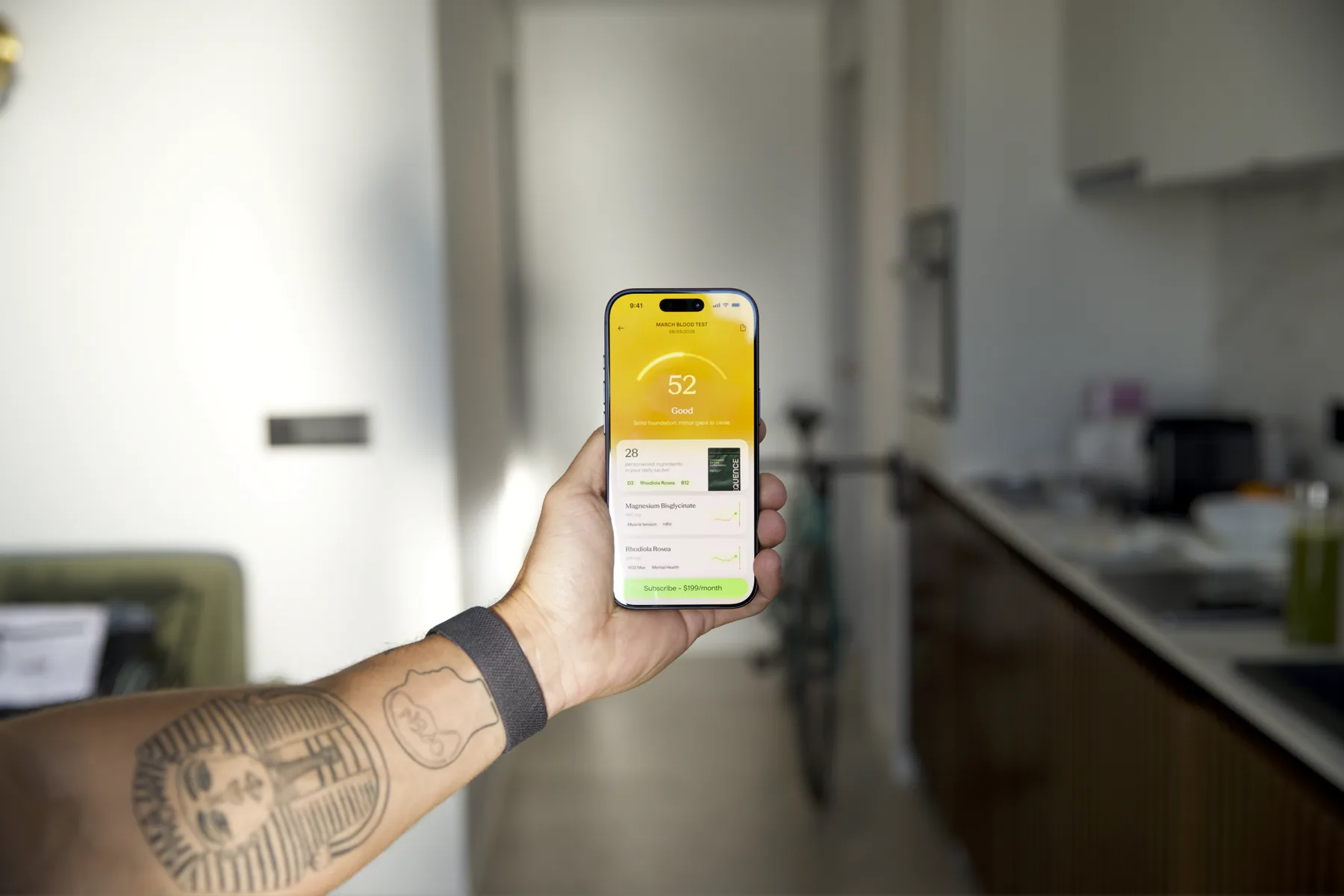 A hand holding a phone showing the SEQUENCE app — a daily health score and personalised formula
