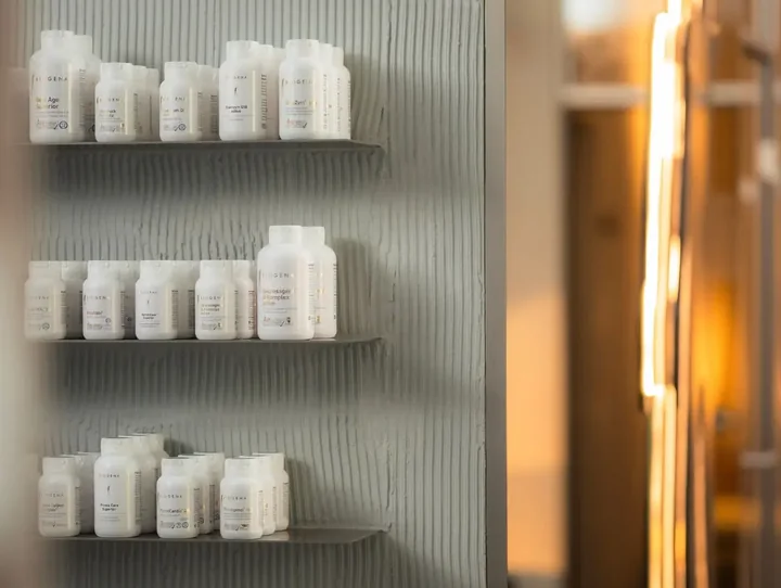 Shelves of off-the-shelf supplement bottles in a clinic dispensary