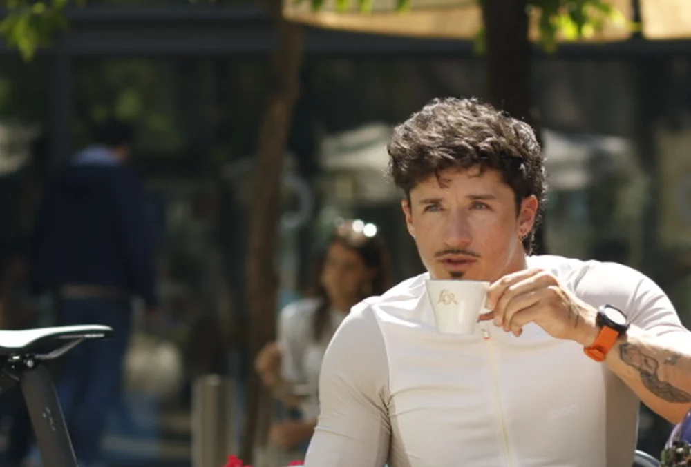 A cyclist recovering with a coffee after training