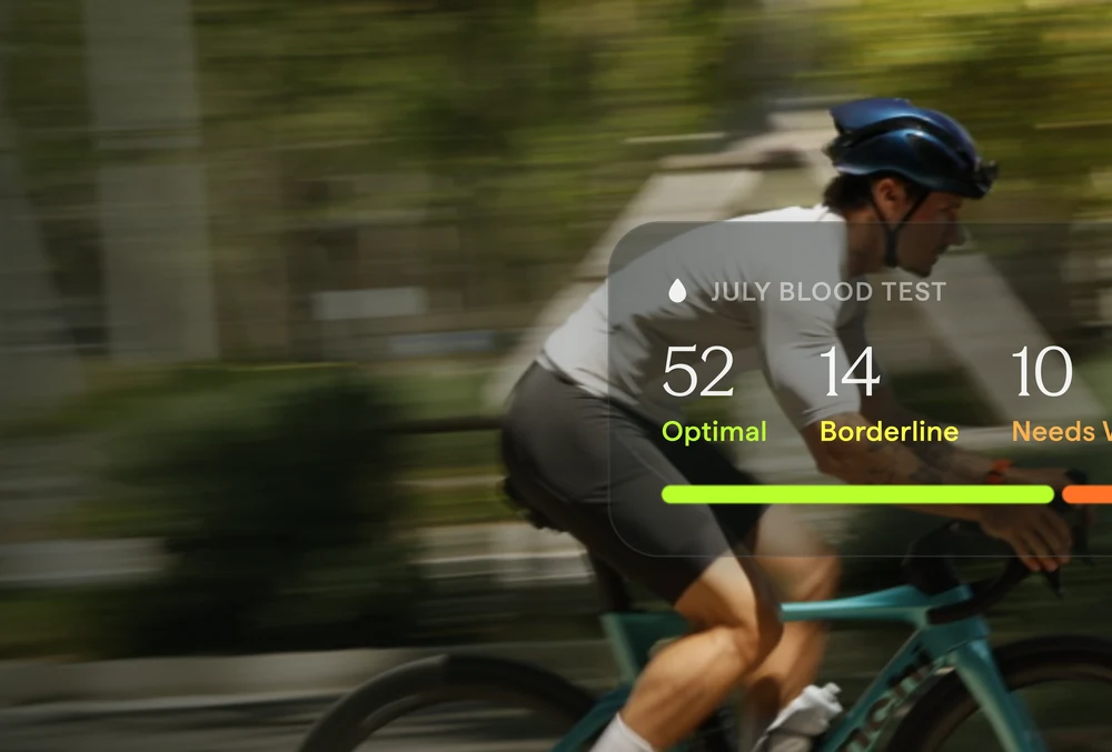 A cyclist, with a July blood-test summary: 52 optimal, 14 borderline, 10 needs work.